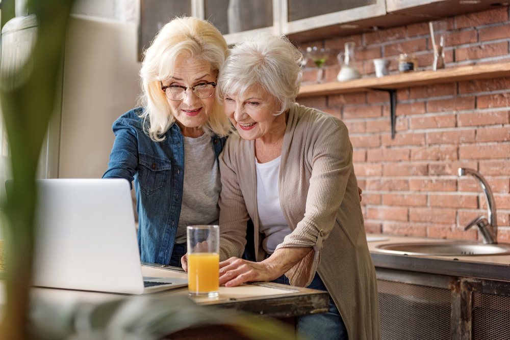 two retirees using a laptop