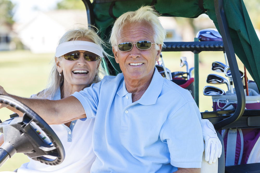retired golfers in a golf cart