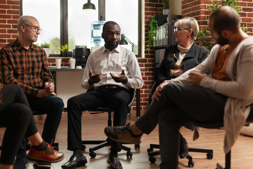 therapist talking to a group of retirees