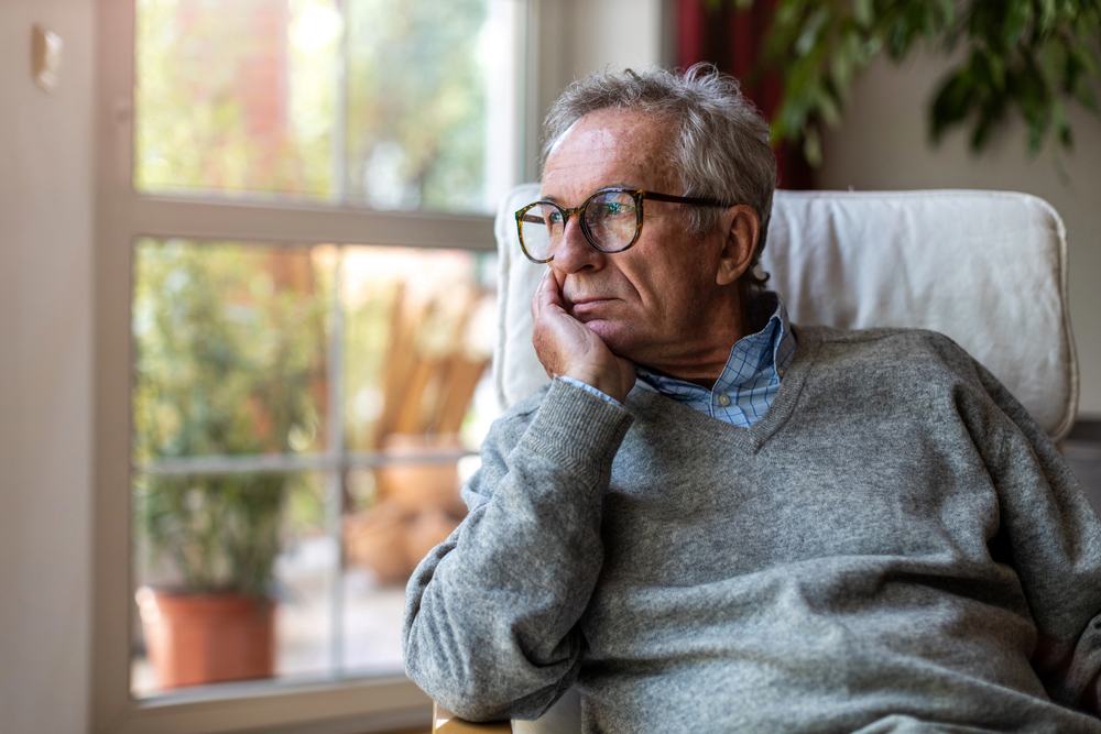 lonely retiree staring out the window