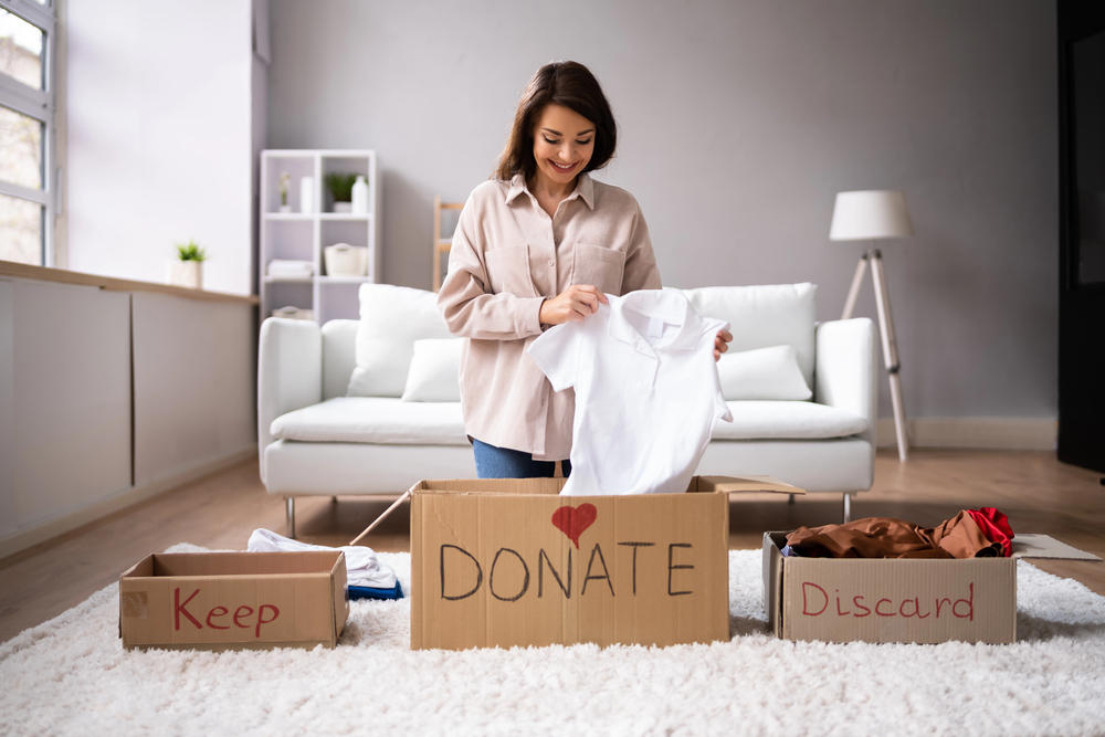 woman donating clothes to declutter her home