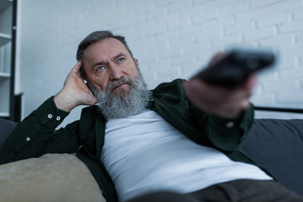 newly retired man wasting time watching tv