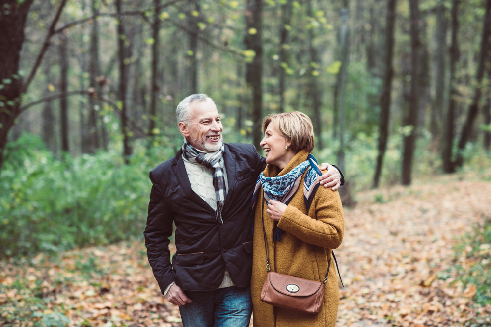 happy retirees walking on a trail